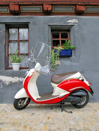 Trendy moped against old building. Fribourg, Switzerland の写真素材