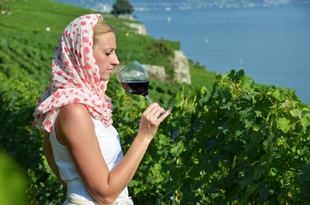 Woman tasting red wine in Lavaux, Switzerland の写真素材