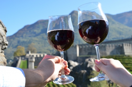 Pair of wineglasses in the hands  Bellinzona, Switzerlandの写真素材