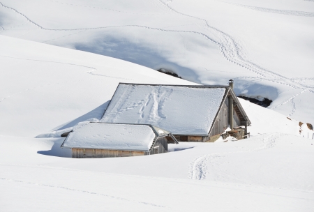 Farm house buried under snow, Melchsee-Frutt, Switzerlandの写真素材