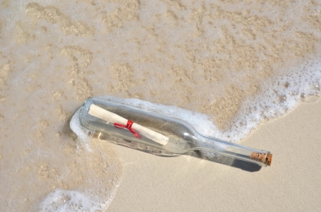 Bottle with a message on the beachの写真素材