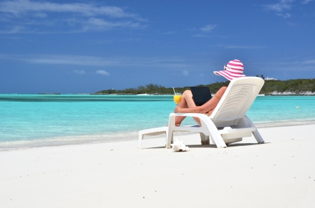 Girl with a laptop on the tropical beachの写真素材