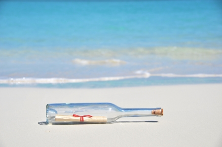 Bottle with a message on the beachの写真素材