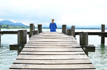 Girl on the wooden jetty  Switzerlandの写真素材