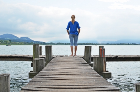 Girl on the wooden jetty. Switzerlandの写真素材