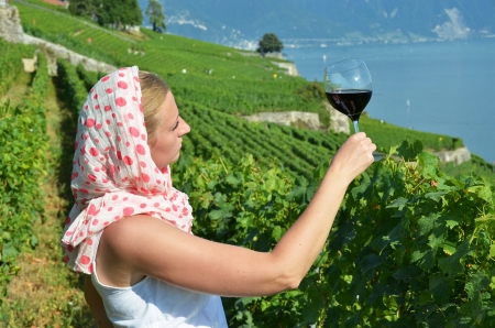 Woman tasting red wine in Lavaux, Switzerland の写真素材