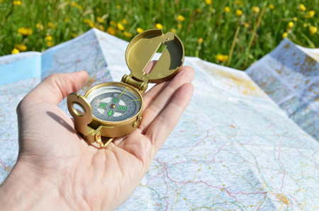 Compass in the hand against a map