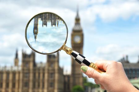 Magnifying glass in the hand against Big Ben in London の写真素材