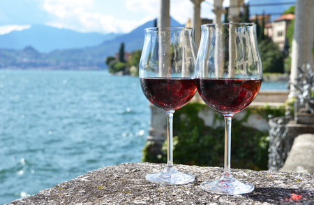 Two wineglasses. Varenna town at the lake Como, Italyの写真素材