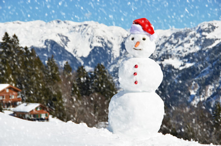 Snowman against Alpine panoramaの写真素材