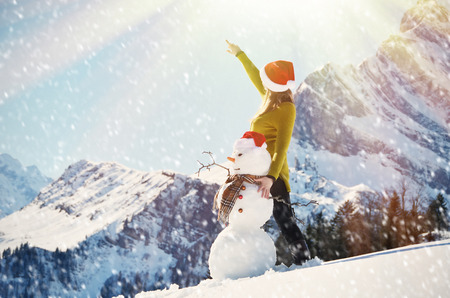 Girl with a snowmanの写真素材