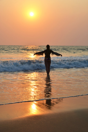 Young woman meditating on Agonda beach. South Goa, Indiaの写真素材