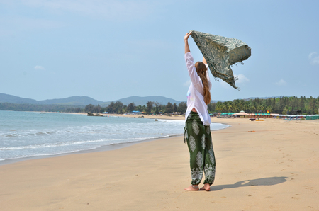 Blond girl relaxing on Agonda beach of South Goa, Indiaの写真素材