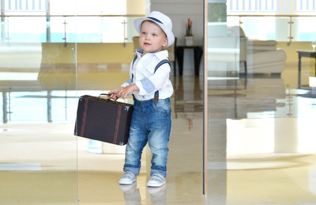 Baby traveler with a suitcaseの写真素材