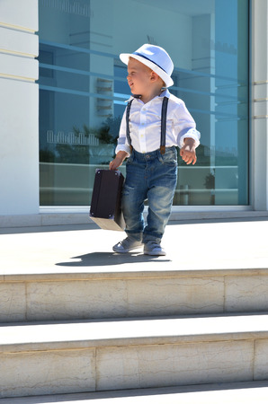 Baby traveler with a suitcaseの写真素材