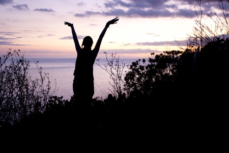 silhouette of a dancing woman in the sunsetの写真素材
