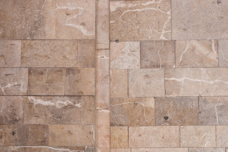 Stone wall or paving background texture with neat cut rectangular bricks or flagstones in random sizes arranged in rowsの写真素材