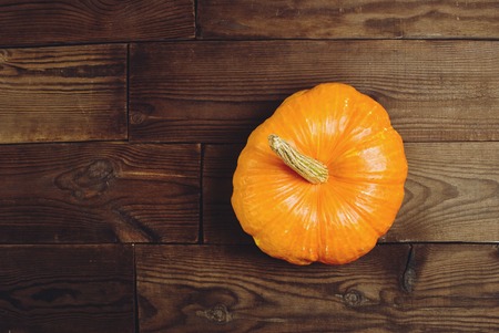 orange pumpkin on dark wooden backgroundの写真素材