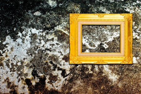 Rough old wall with vintage gold frameの写真素材