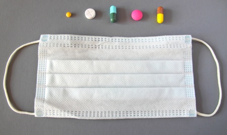 Set of various medical pills and mask on grey backgroundの写真素材