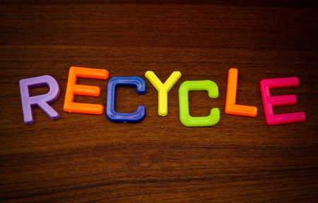 Recycle in colorful toy letters on wood backgroundの写真素材