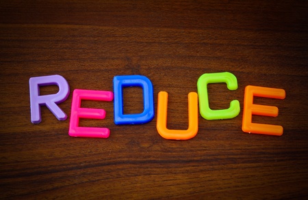 Reduce in colorful toy letters on wood backgroundの写真素材