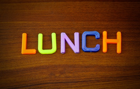 Lunch in colorful toy letters on wood background の写真素材