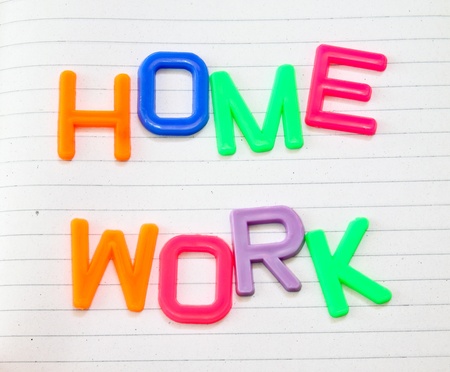 Homework in colorful toy letters on lined paper backgroundの写真素材
