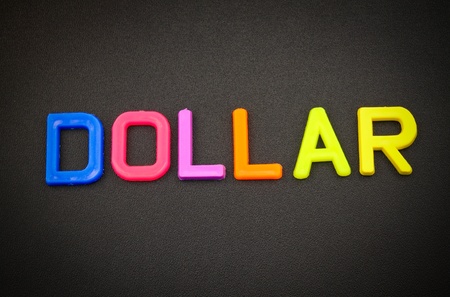 Dollar in colorful toy letters on black backgroundの写真素材