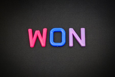 Won in colorful toy letters on black backgroundの写真素材