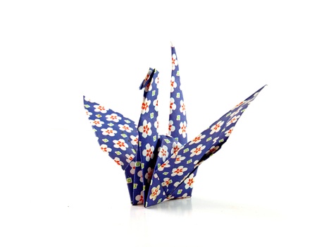 Crane origami bird folded with a floral pattern paper の写真素材