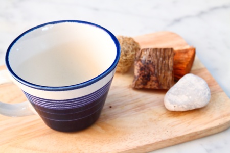 empty cup on chopping boardの写真素材