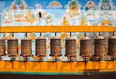 Buddhist prayer wheels with ancient art wall, Nepalのeditorial素材