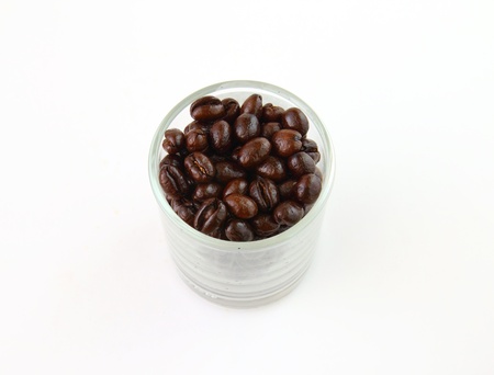 Coffee beans in a glass on white backgroundの写真素材