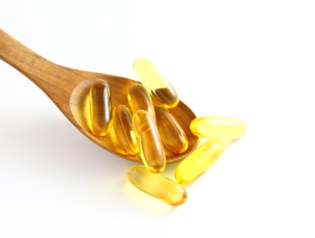 vitamins in wooden spoon on white backgroundの写真素材