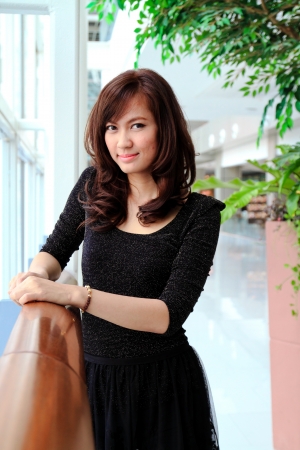Beautiful asian woman smiling in modern buildingの写真素材