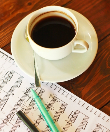 Hot coffee on music note with penの写真素材