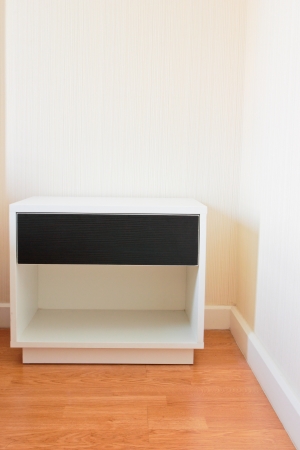 Modern bedside table with drawer on wooden floorの写真素材