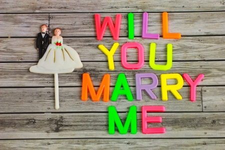 wedding bride and groom couple doll with will you marry me colorful plastic letterpressの写真素材