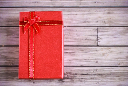 Red present box on wooden backgroundの写真素材