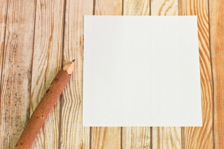 Pencil wood bark with paper note on wooden backgroundの写真素材