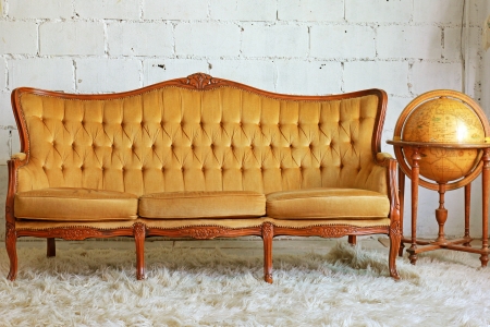 Vintage furniture sofa with old globeの写真素材