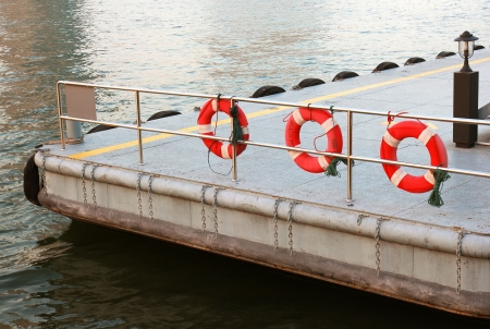 Life preserver and pontoon on the riverの写真素材