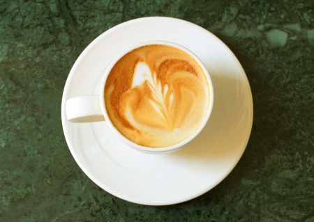 Cappuccino or latte coffee on tableの写真素材