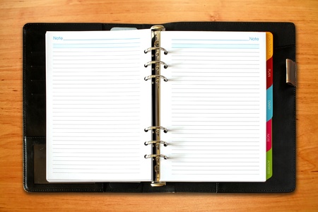leather open notebook on old wooden backgroundの写真素材