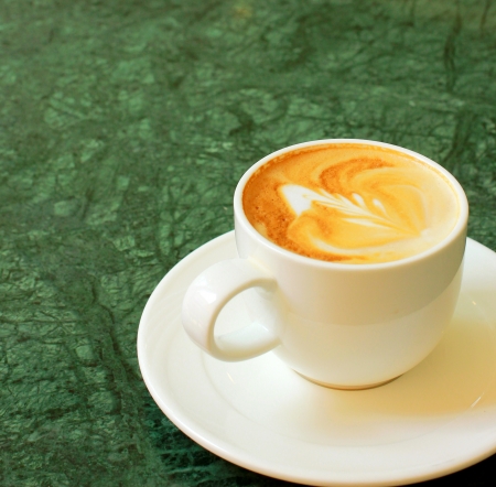 Cappuccino or latte coffee on table の写真素材