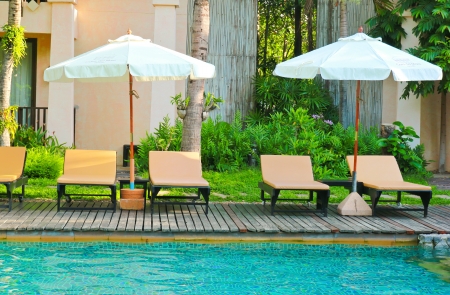 Beach chairs and umbrella side swimming poolのeditorial素材