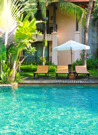 Beach chairs and umbrella side swimming poolのeditorial素材