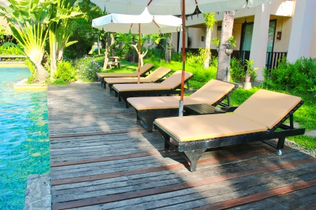 Beach chairs and umbrella side swimming poolのeditorial素材