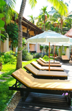 Beach chairs and umbrella side swimming poolのeditorial素材